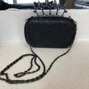 Spiky “brass knuckle” clutch w. crossbody attached